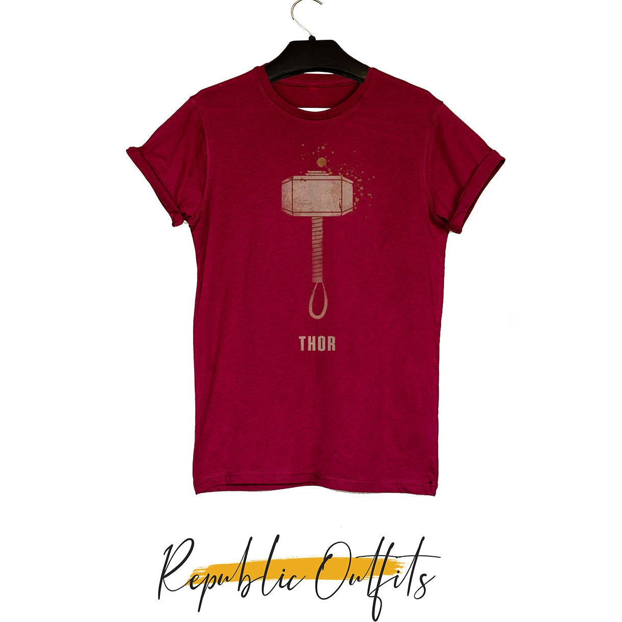 A maroon graphic T-shirt featuring a bold Thor hammer graphic print on the front with a crewneck and short sleeves, displayed on a hanger.